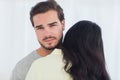 Woman giving hug to uninterested boyfriend Royalty Free Stock Photo