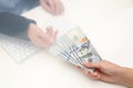 Woman giving money to teller at cash department window Royalty Free Stock Photo