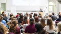 Woman giving presentation in lecture hall at university. Royalty Free Stock Photo