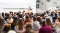 Woman giving presentation in lecture hall at university.