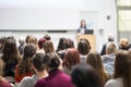 Woman giving presentation in lecture hall at university. Royalty Free Stock Photo