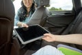 Woman giving tablet pc to her child in car Royalty Free Stock Photo