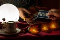 Woman giving a tarot card to fortune teller woman