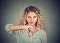 Woman giving thumb down gesture looking with negative expression Royalty Free Stock Photo