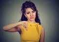 Woman giving thumb down gesture looking with negative expression Royalty Free Stock Photo