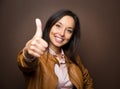 Woman giving thumbs up approval hand sign gesture smiling Royalty Free Stock Photo