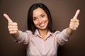 Woman giving thumbs up approval hand sign gesture smiling happy Royalty Free Stock Photo