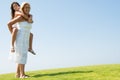 Woman giving young girl piggyback ride Royalty Free Stock Photo