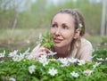 Woman on a glade of blossoming snowdrops in the early spring Royalty Free Stock Photo