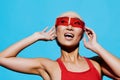 Woman emotion blue smiling beauty swimsuit asian red fashionable fashion sunglasses portrait Royalty Free Stock Photo