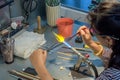 Woman glass artist making decoration in her workshop