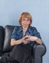 Woman with a glass brandy on couch Royalty Free Stock Photo
