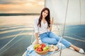 Woman with glass of champagne resting on yacht Royalty Free Stock Photo