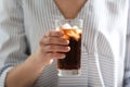 Woman with glass of cold cola