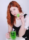 Red haired woman with a glass of green beer. St. Patrick`s Day. Royalty Free Stock Photo