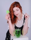 Red haired woman with a glass of green beer. St. Patrick`s Day. Royalty Free Stock Photo