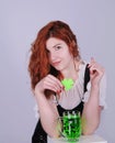 Red haired woman with a glass of green beer. St. Patrick`s Day. Royalty Free Stock Photo