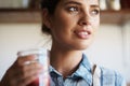 Woman, glass and juice with kitchen, closeup and person with smoothie for health or wellness. Nutritionist, drink and