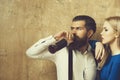 Woman with glass looking at man drinking wine from bottle Royalty Free Stock Photo