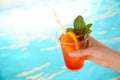 Woman with glass of refreshing drink near swimming pool. Space for text Royalty Free Stock Photo