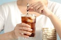 Woman with glass of tasty refreshing cola, closeup