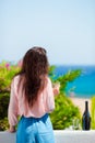 Woman with glasses and bottle of tasty wine on balcony in greek island with view of sea Royalty Free Stock Photo