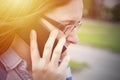 Woman in glasses close up portrait with phone