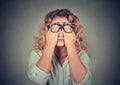 Woman in glasses covering face eyes with both hands Royalty Free Stock Photo