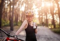 Woman holding bottle next to bike Royalty Free Stock Photo