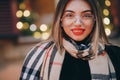 Woman with glasses look at camera poses in city center Beautiful hair attractive smile girl. Close up shot Woman with Royalty Free Stock Photo