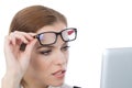 Woman with glasses looking at her laptop