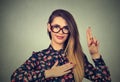 Woman in glasses making a promise isolated on gray wall background Royalty Free Stock Photo