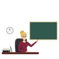 Woman with glasses sits at a table and points to a blackboard. Teacher with a pointer
