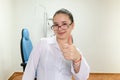 A woman with glasses is smiling and giving a thumbs up gesture Royalty Free Stock Photo