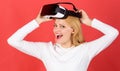 The woman with glasses of virtual reality. Person with virtual reality helmet isolated on red background. Amazed young Royalty Free Stock Photo