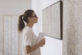 Woman standing in the art gallery and looking at the paintings Royalty Free Stock Photo