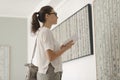 Woman standing in the art gallery and looking at the paintings