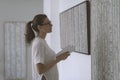 Woman standing in the art gallery and looking at the paintings Royalty Free Stock Photo