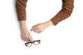 Woman with glasses on white background, top view. Closeup of hands Royalty Free Stock Photo