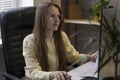 Woman with glasses work on the PC with documents. Business woman in office solves working issues