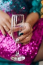 Woman glittery red dress glass champagne toast