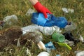 Woman in gloves collecting garbage in nature, closeup Royalty Free Stock Photo