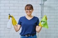Woman in gloves with detergent spray washcloth doing cleaning in bathroom Royalty Free Stock Photo