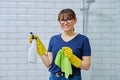 Woman in gloves with detergent spray washcloth doing cleaning in bathroom Royalty Free Stock Photo