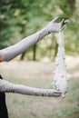 Woman in gloves holding a string bag with beads