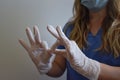 Woman with gloves interpreting sign language in a medical setting