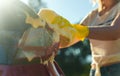 Woman in gloves washes the car back light Royalty Free Stock Photo