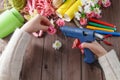 Woman glue handmade flowers with melt gun Royalty Free Stock Photo