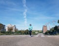 Woman goes for a run on the empty street during the confinement of the Covid-19 in Valdebebas, Madrid, Spain Royalty Free Stock Photo