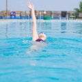 Woman in goggles swimming back crawl style Royalty Free Stock Photo